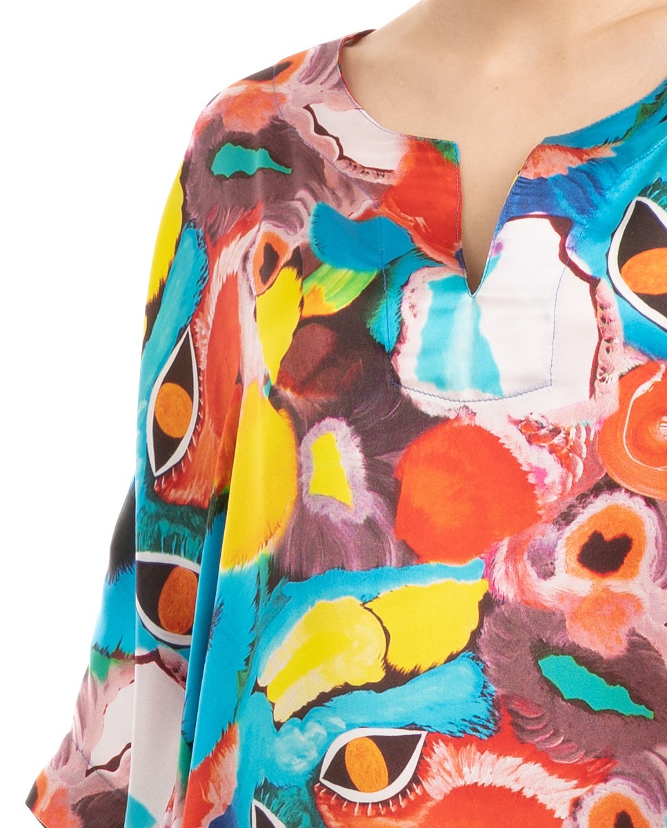 Vista detalle del cuello abierto del kaftan en seda estampado de verano