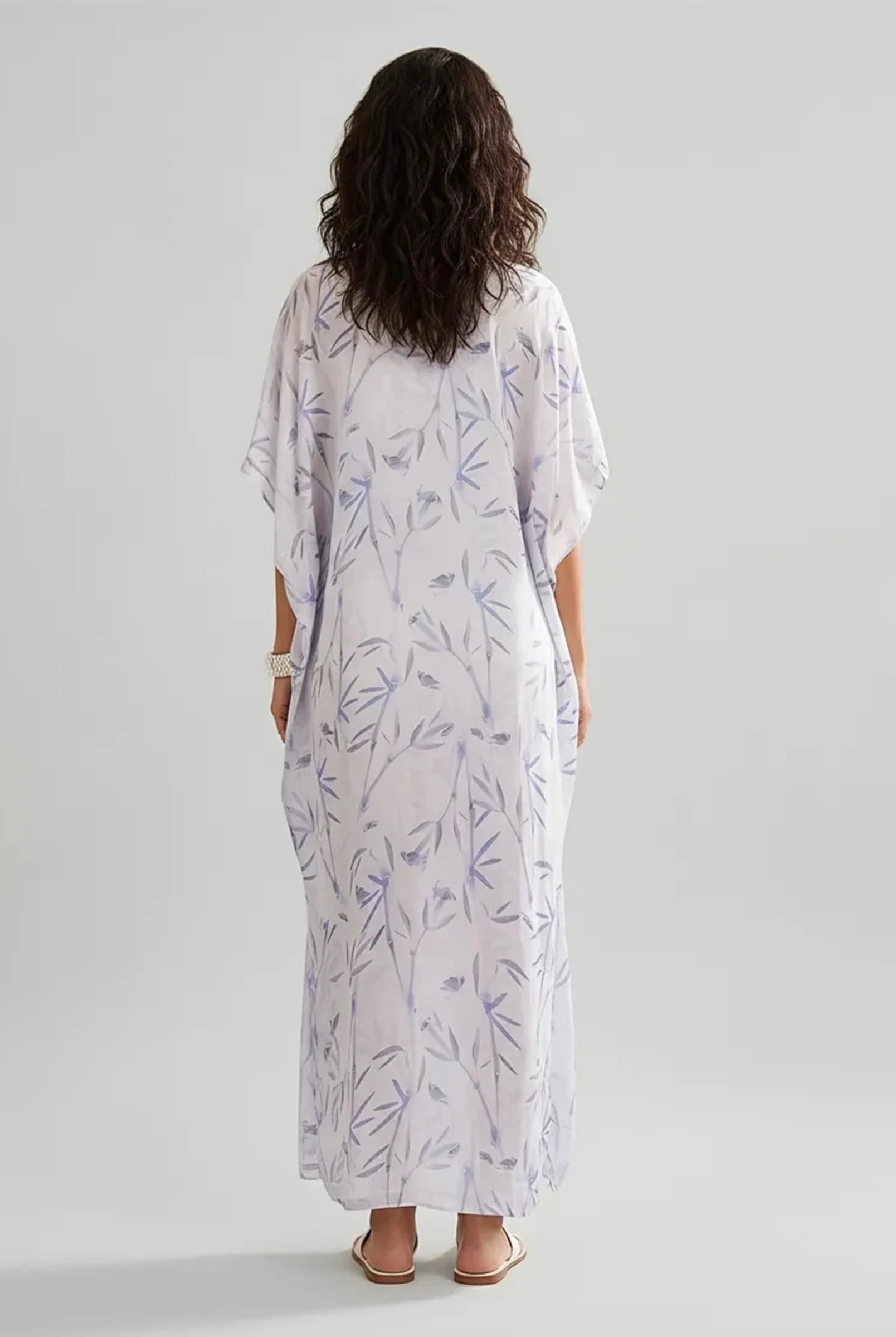 Mujer de espaldas con caftan de verano largo de seda natural estampado