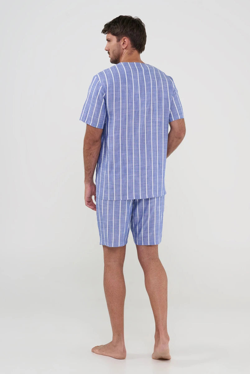 Hombre de espaldas con pijama fresco estilo camisero azul de rayas para verano