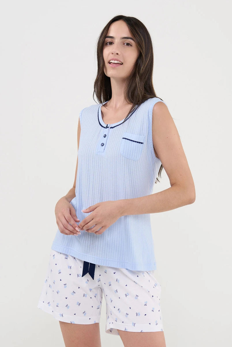 Mujer con pijama de verano corto sin mangas en punto celeste acanalado y pantalón blanco de cerezas.