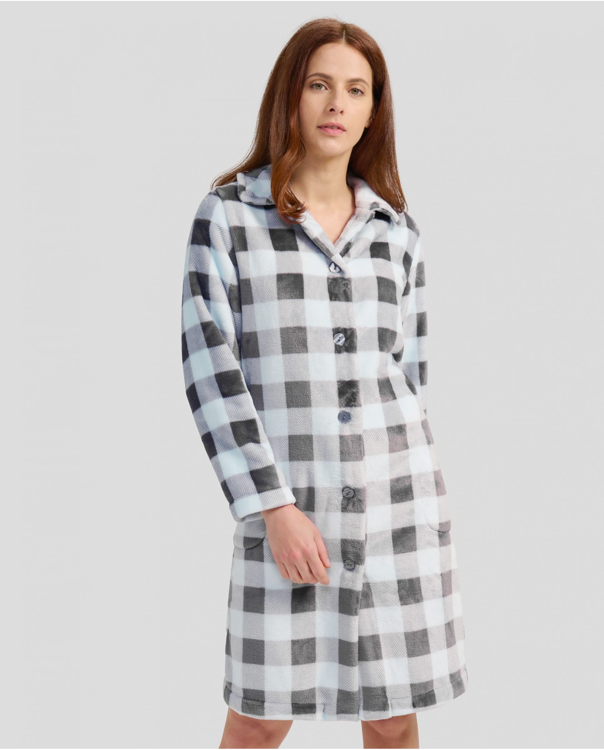 Woman in light blue plaid winter coat with buttoned buttons and pockets