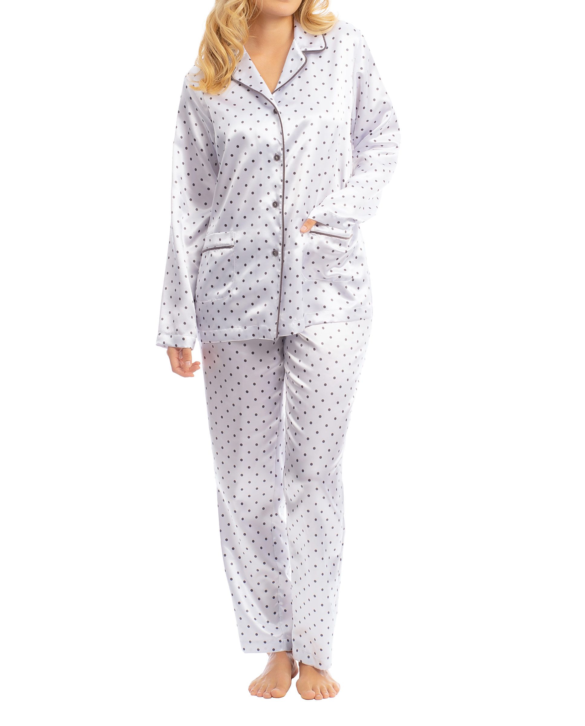 Woman in elegant long winter pyjamas in white satin with polka dot pattern