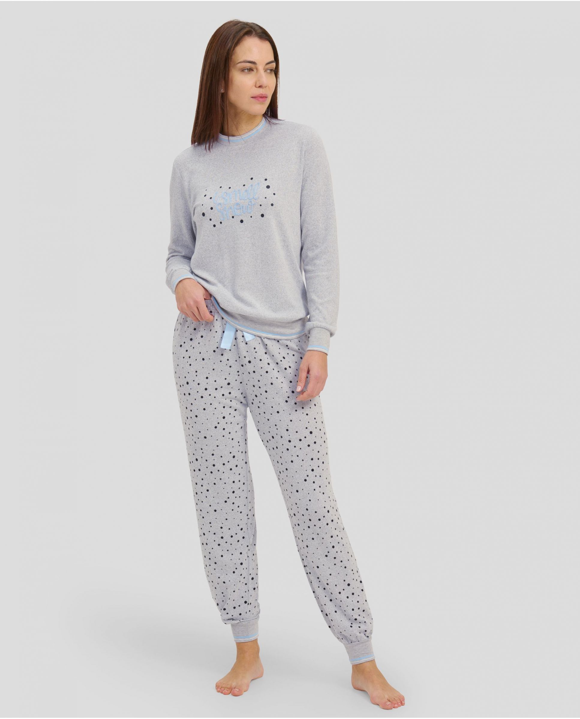 Woman in grey long winter pyjamas with closed collar and cuffs