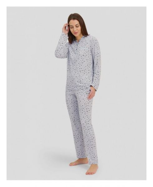 Woman with long-sleeved winter pyjamas in grey taupe with polka dot pattern