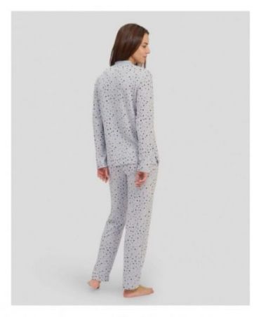 Rear view of woman in long grey polka dot winter pyjamas