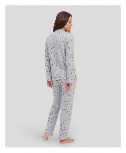 Rear view of woman in long grey polka dot winter pyjamas