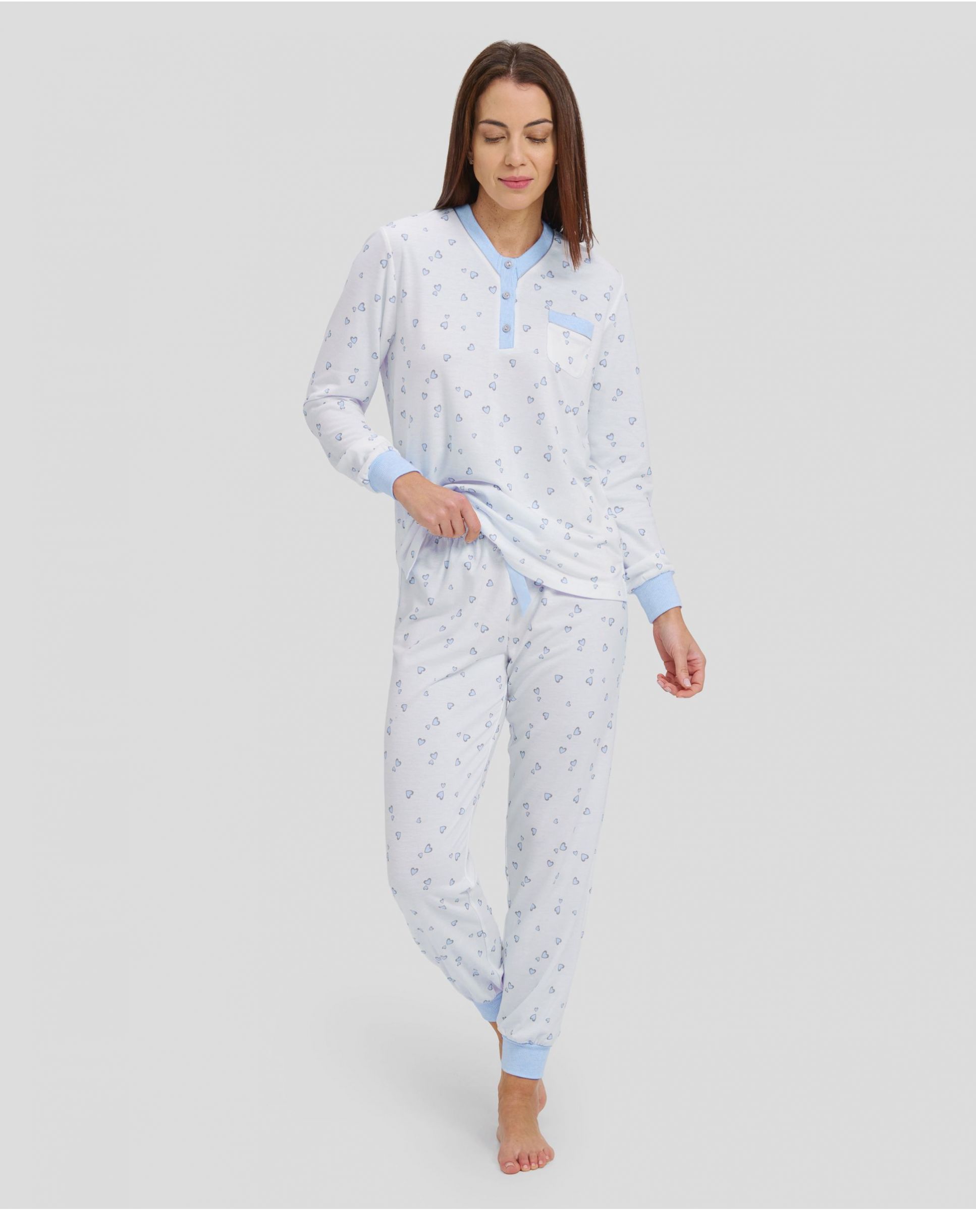 woman with long winter pyjamas with light blue heart print