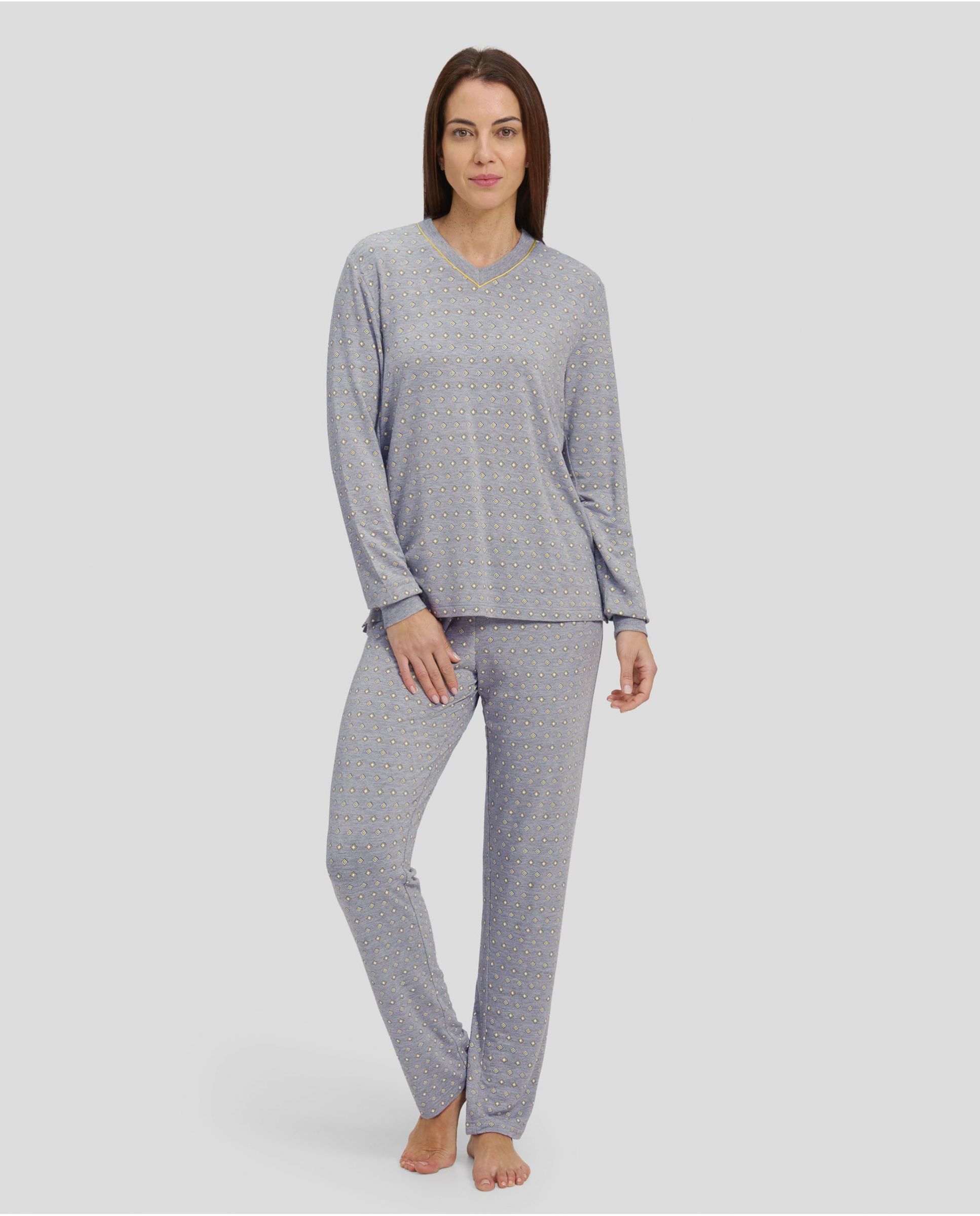 Woman in grey winter pyjamas with diamond pattern with cuffs and V-neck collar