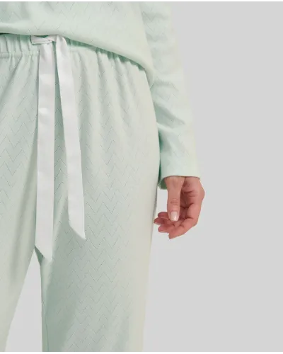 Woman in soft green lingerie winter pyjamas with V-neck and lace