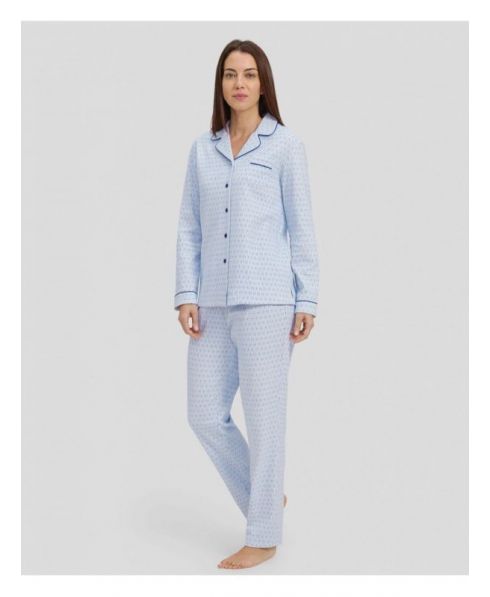 Woman in light blue shirt pyjamas with buttoned ovals and contrasting piped collar.