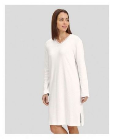 Woman in ivory long-sleeved winter lingerie nightdress with V-neck and lace collar