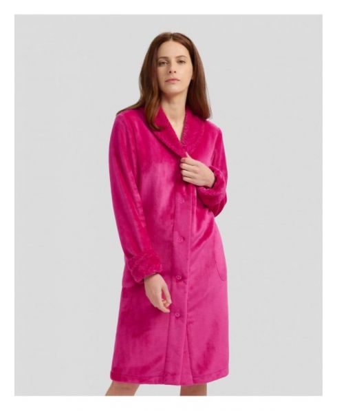 Woman in fuchsia flannel long dressing gown, buttoned and with pockets for winter