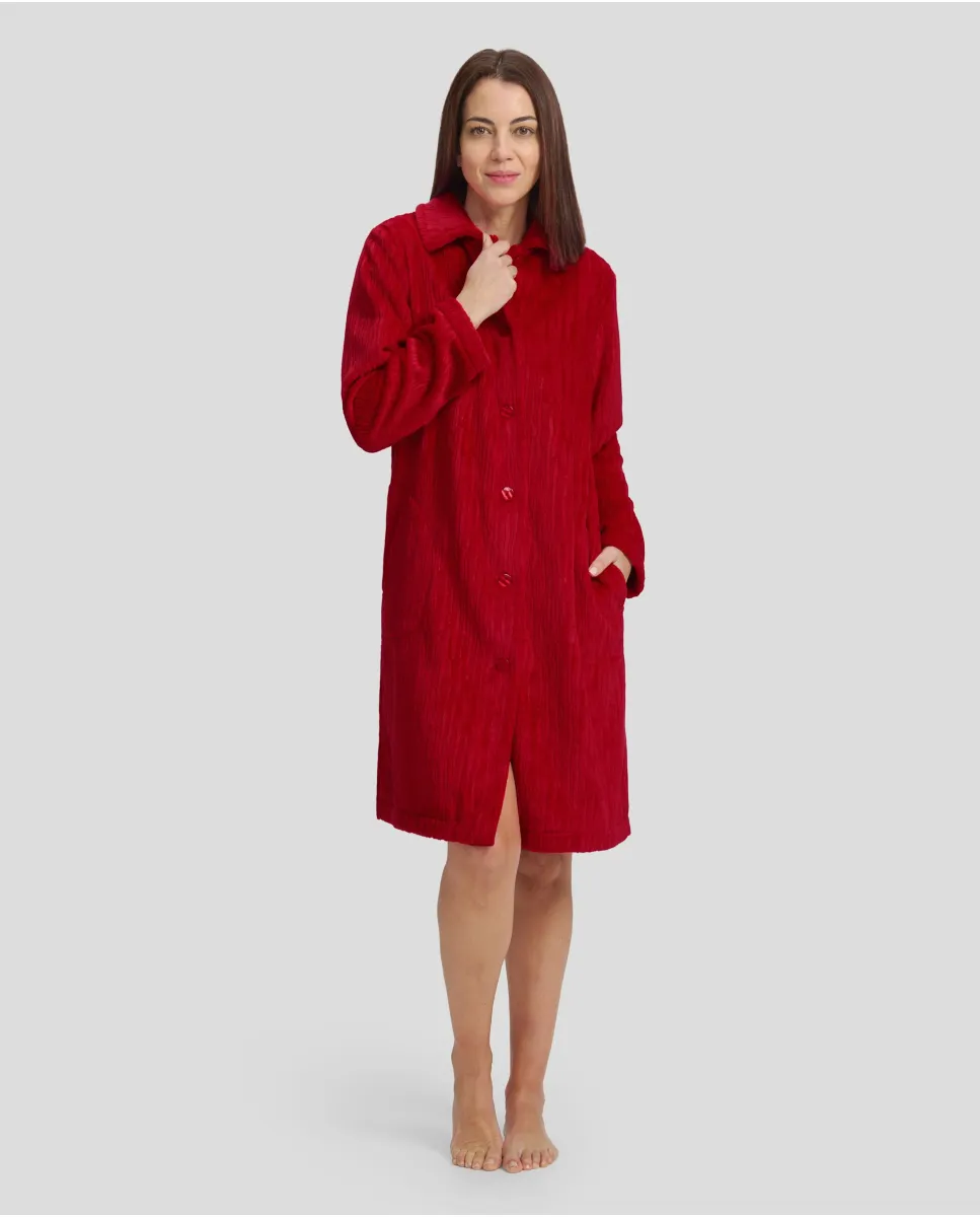 Woman in red jacquard buttoned long winter dressing gown with long buttoned pockets