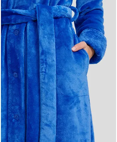 Detail view of lapel collar of royal blue buttoned long winter coat