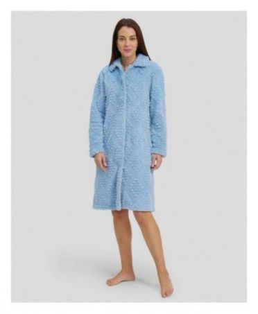 Woman in light blue jacquard long winter coat, buttoned and with pockets