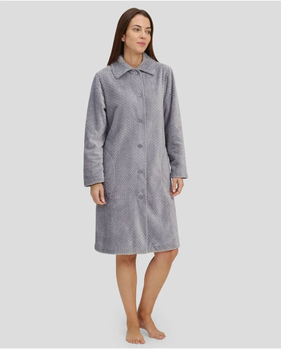 Woman in grey long winter coat, buttoned and with side pockets