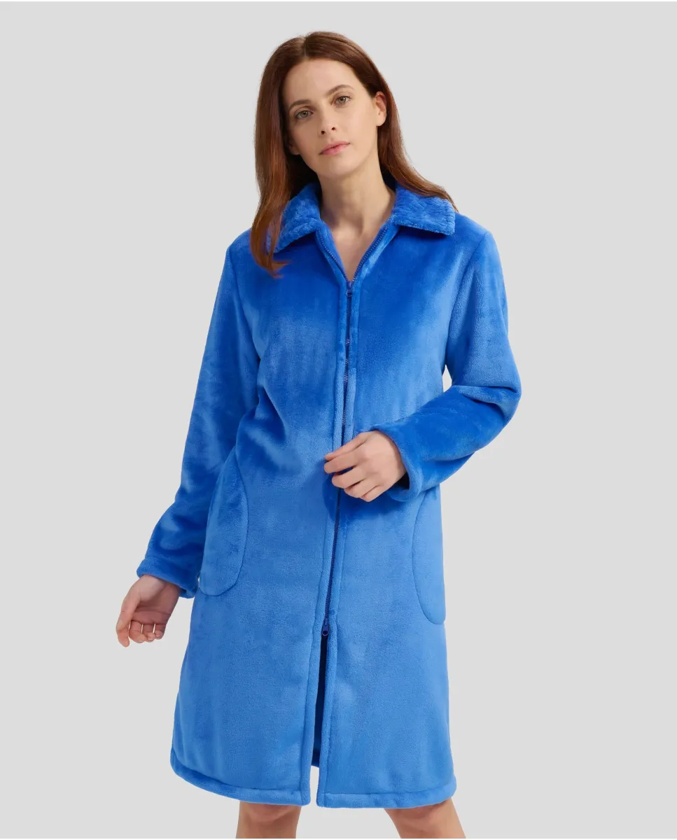 Woman in long blue winter dressing gown with zip and pockets