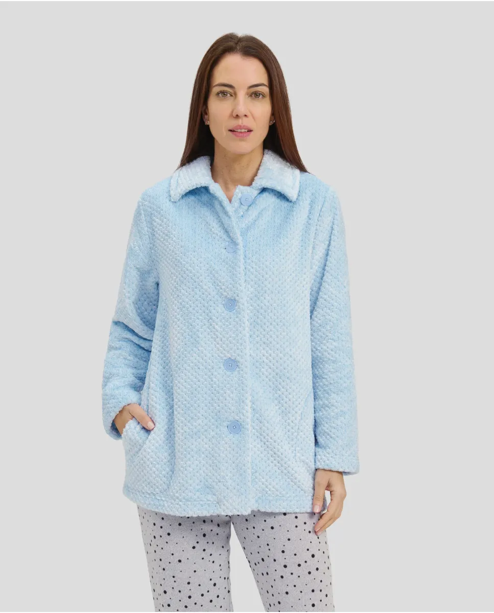 Woman in short light blue buttoned dressing gown with side pockets