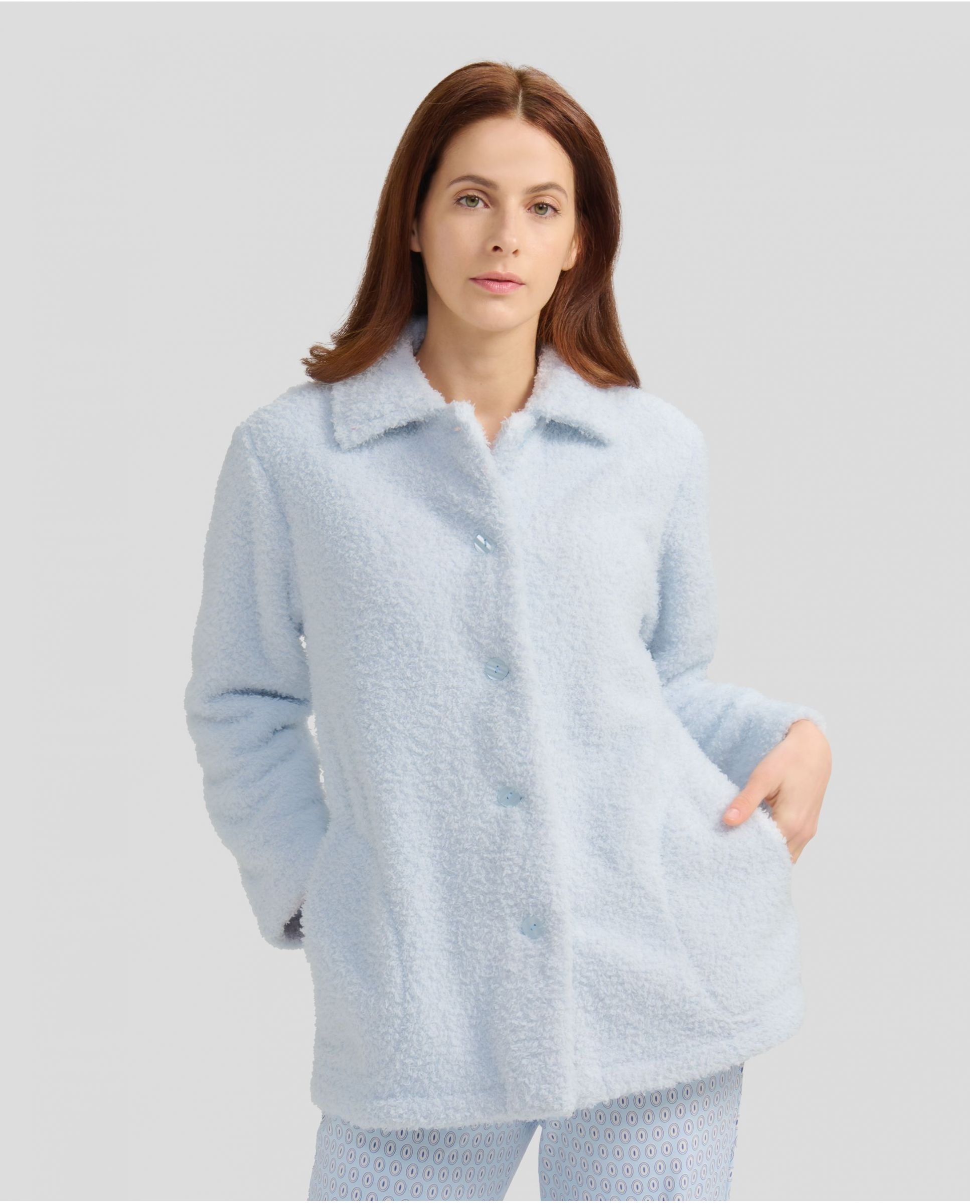 Woman with short light blue sheepskin coat with buttons and pockets