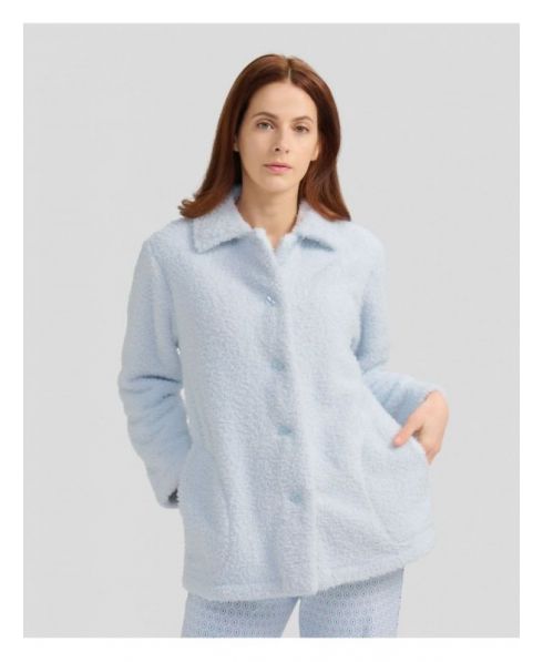 Woman with short light blue sheepskin coat with buttons and pockets