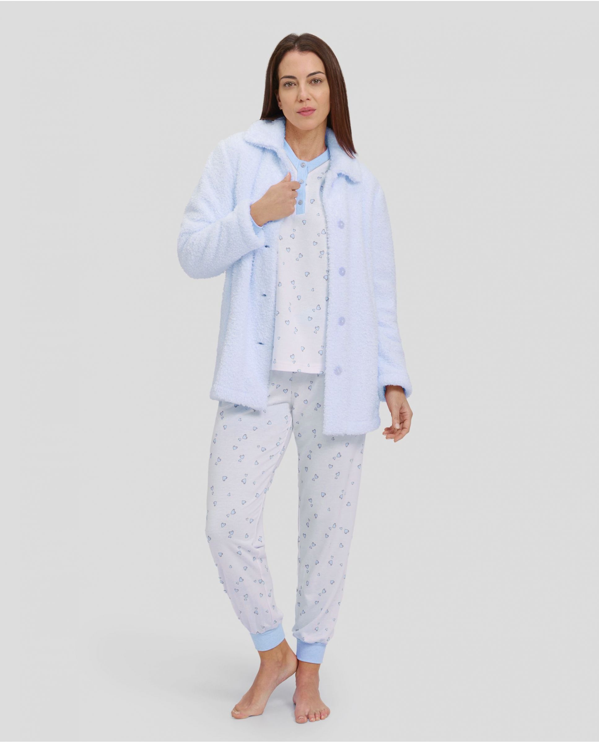 Woman with light blue hearts winter pyjama set and light blue teddy coat with button fastening