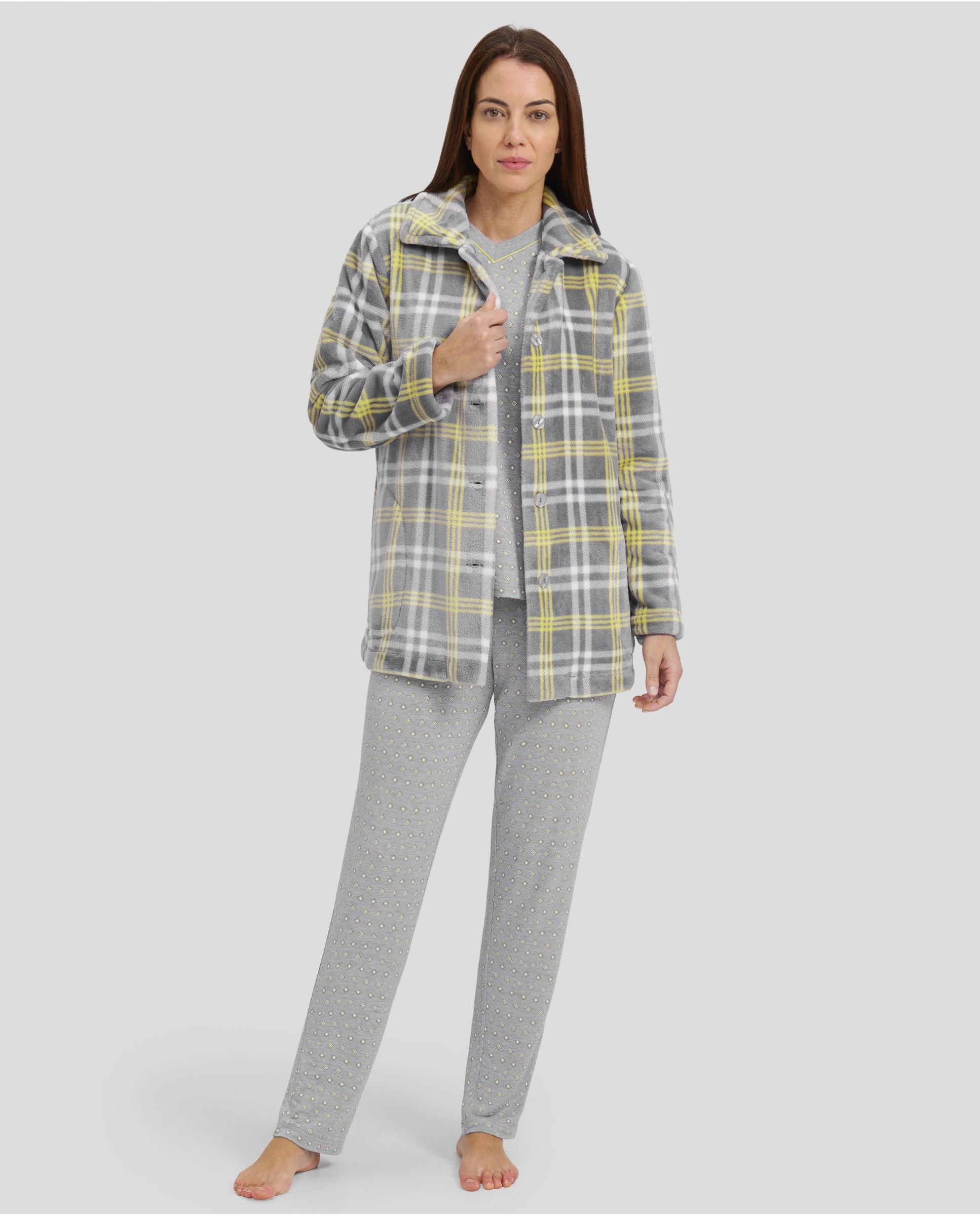 Woman wearing a grey home outfit with long pyjamas and a yellow checked dressing gown.