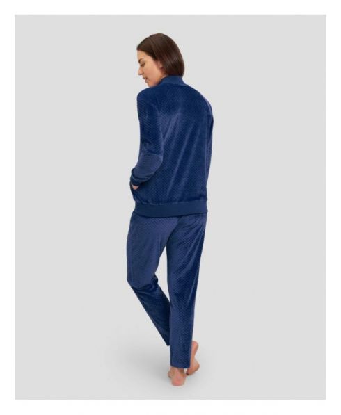 Rear view of woman in navy jacquard velvet tracksuit