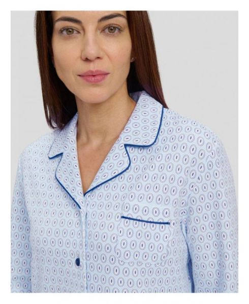 Detail view of the collar of a light blue oval nightgown with blue buttons and piped lapel.