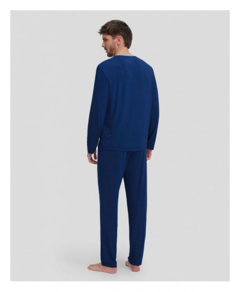 Rear view of man in long blue pyjamas for the winter