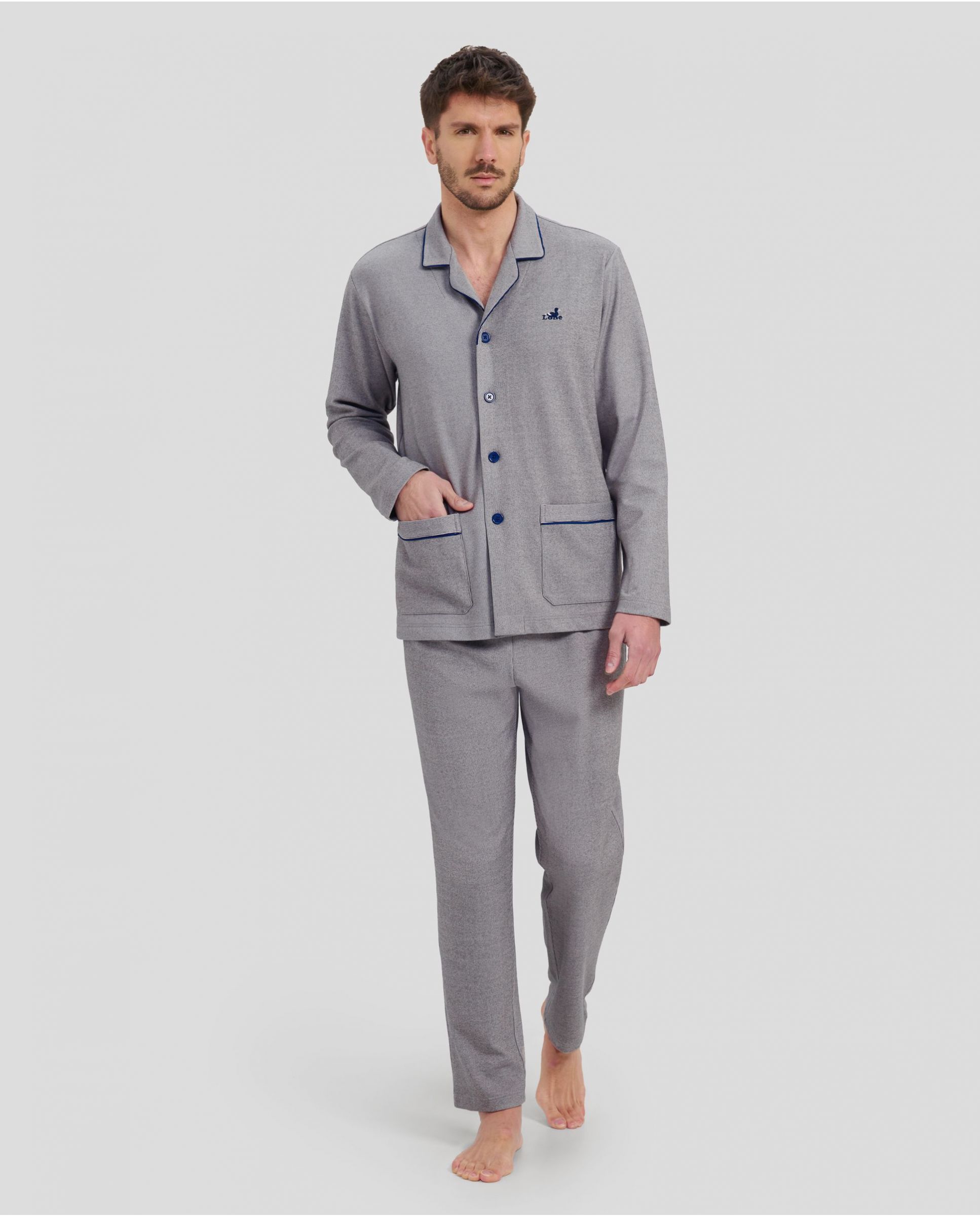 Man in grey plain winter pyjamas with blue piping on the collar