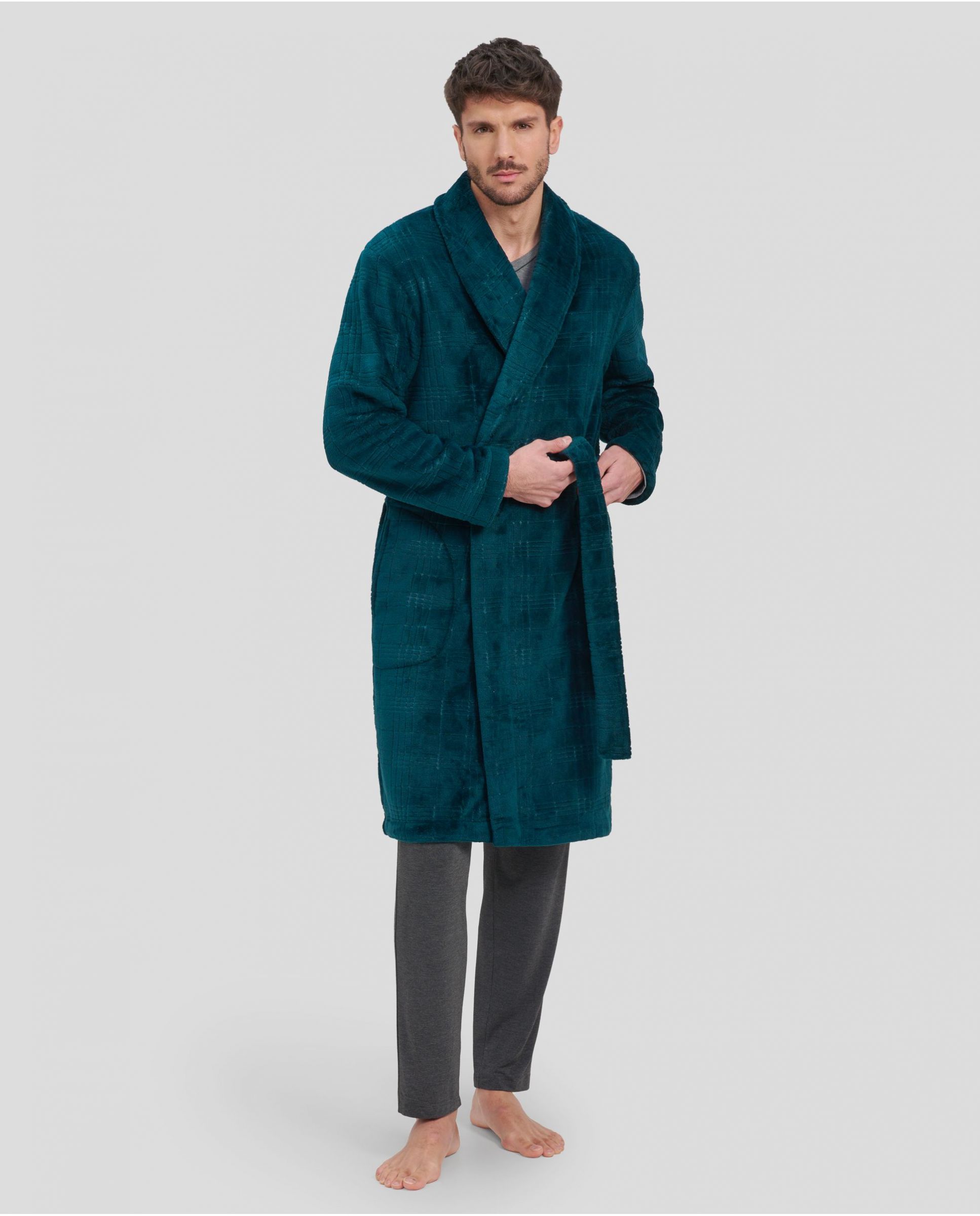 Man in long green double-breasted coat with side pockets