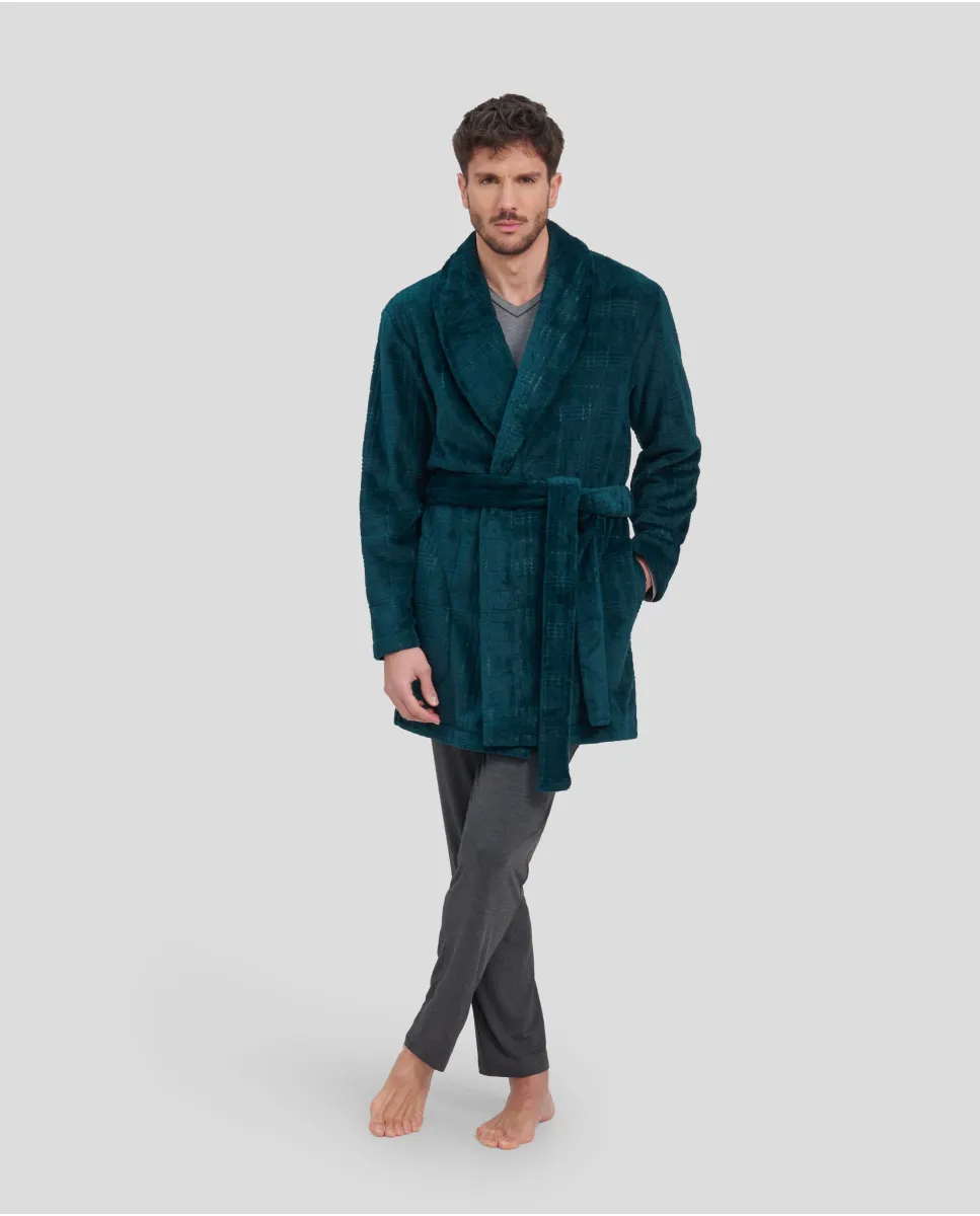 Man in a short green winter coat with pockets and cross over