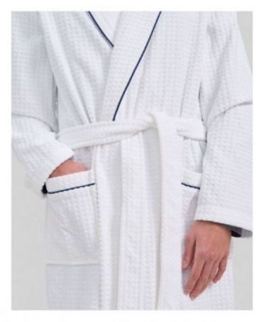 Detail view of white men's bathrobe with pockets and blue piping details