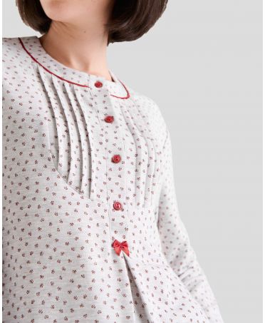 Detail view of lingerie pyjamas with red button-down collar, bow and pleats