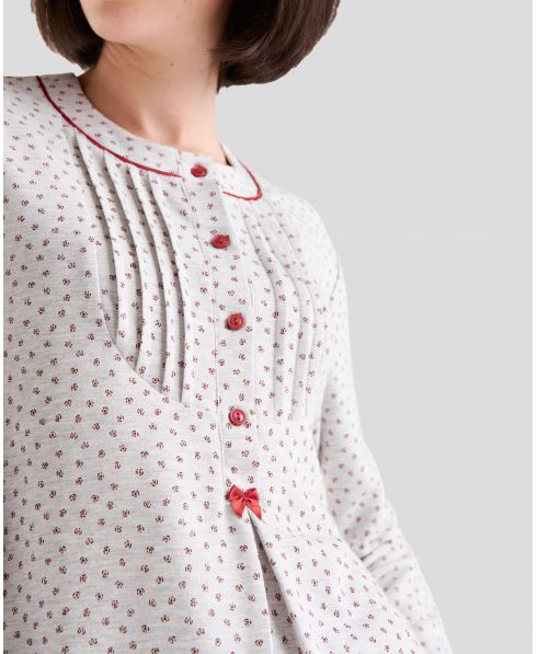 Detail view of lingerie pyjamas with red button-down collar, bow and pleats