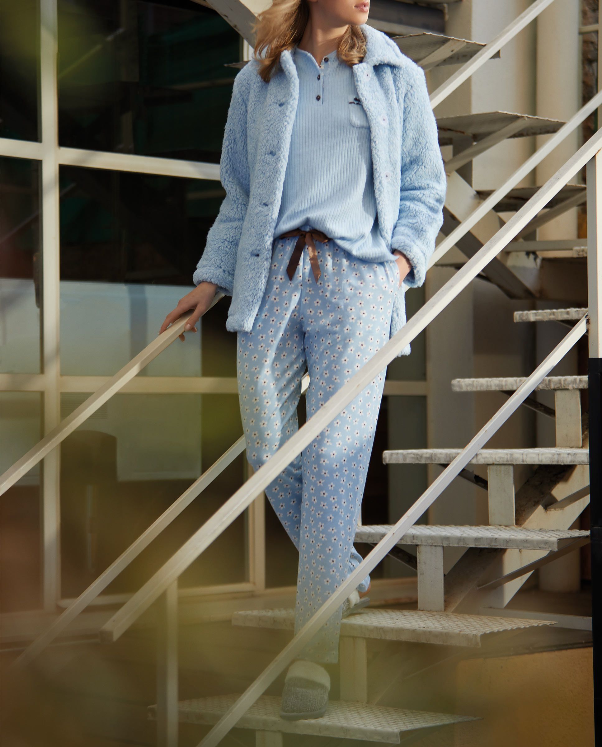 Woman in light blue short coat with sheepskin and pockets