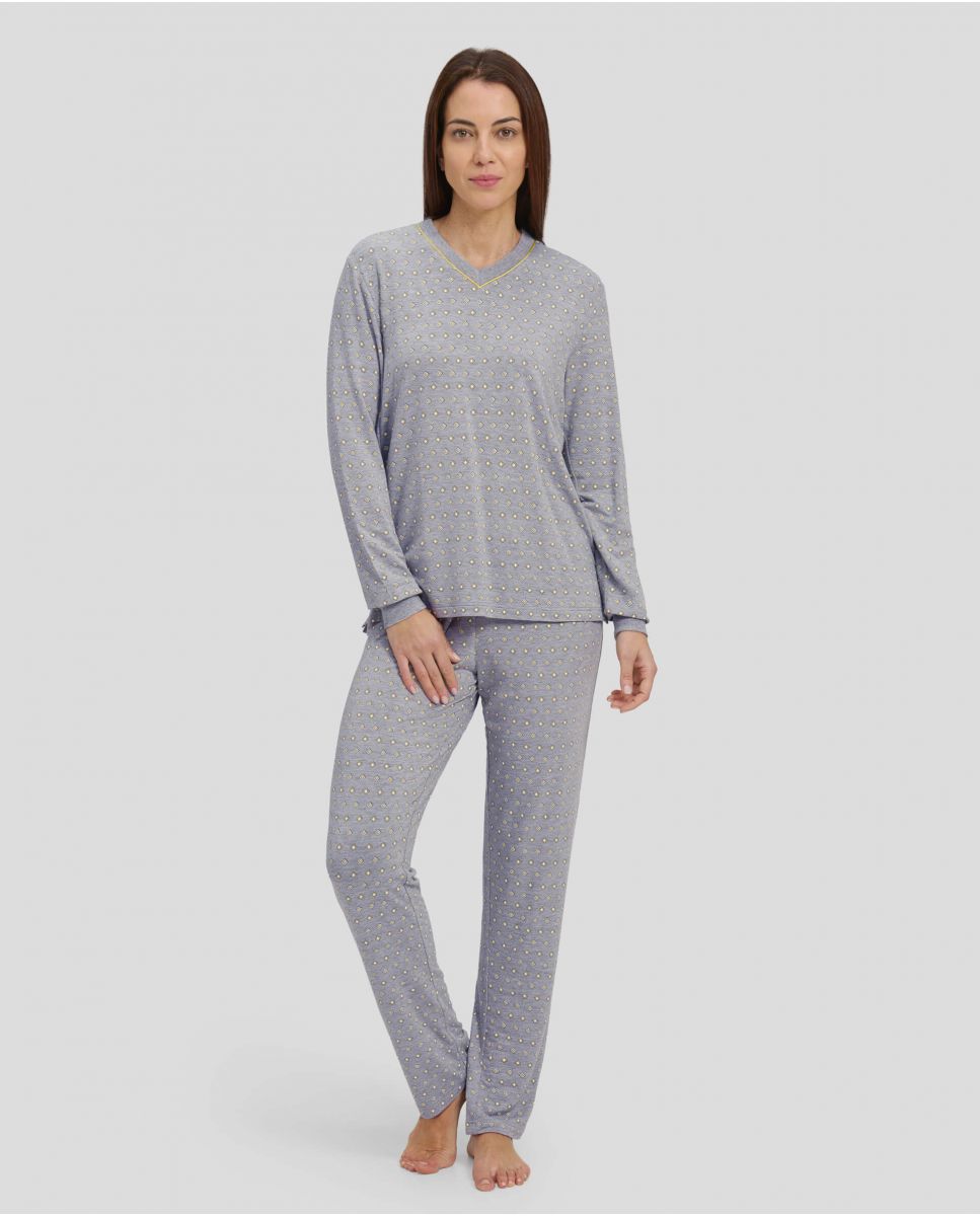 Woman in grey winter pyjamas with diamond pattern with cuffs and V-neck collar