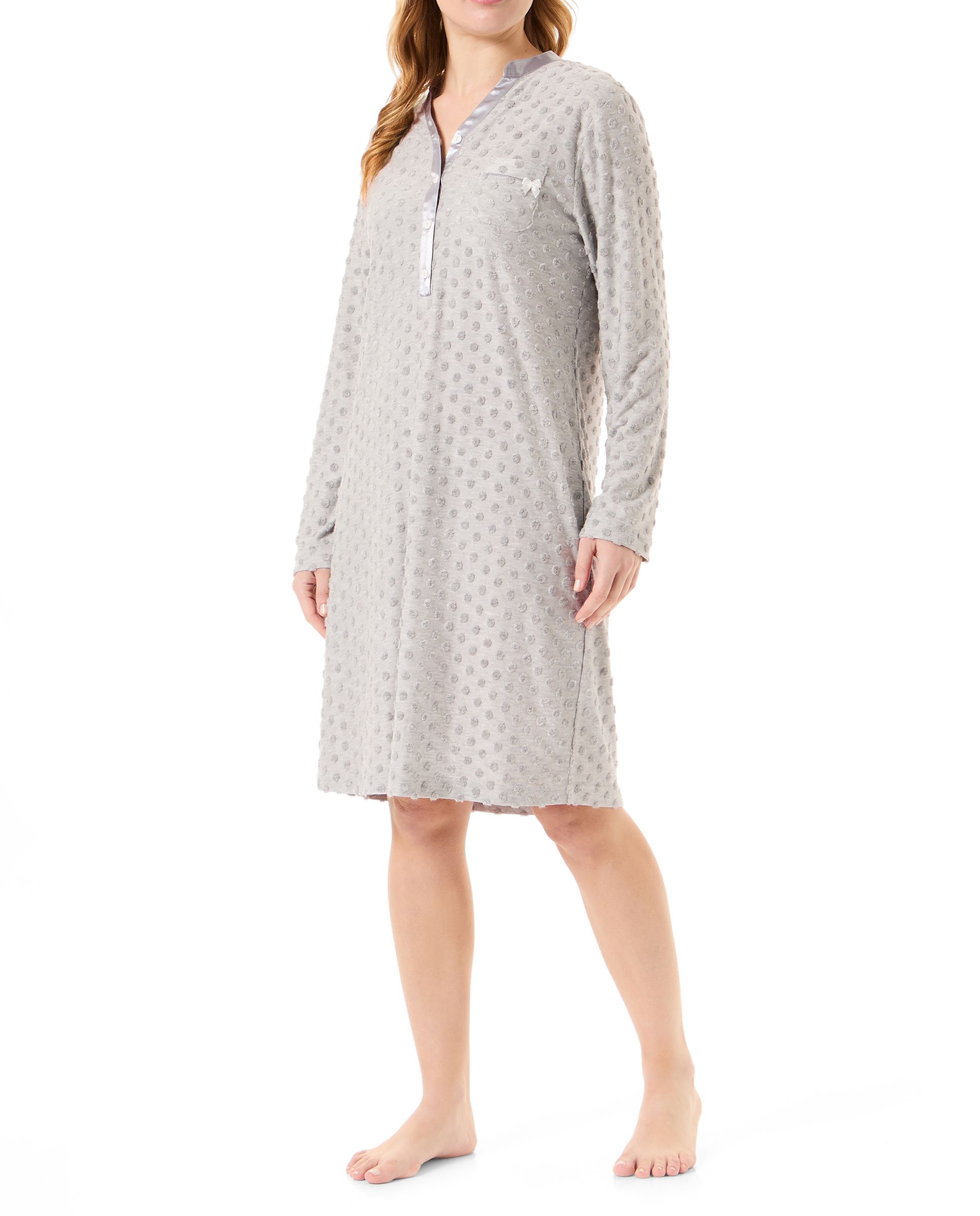 Woman in long grey knitted nightdress with polka dot pattern