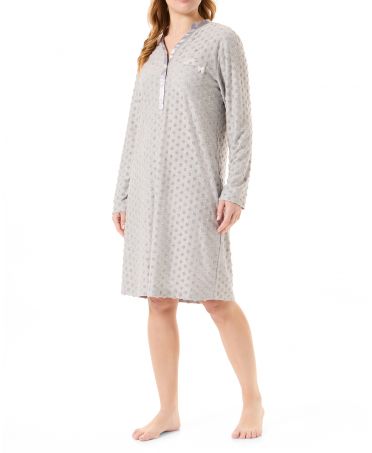 Woman in long grey knitted nightdress with polka dot pattern