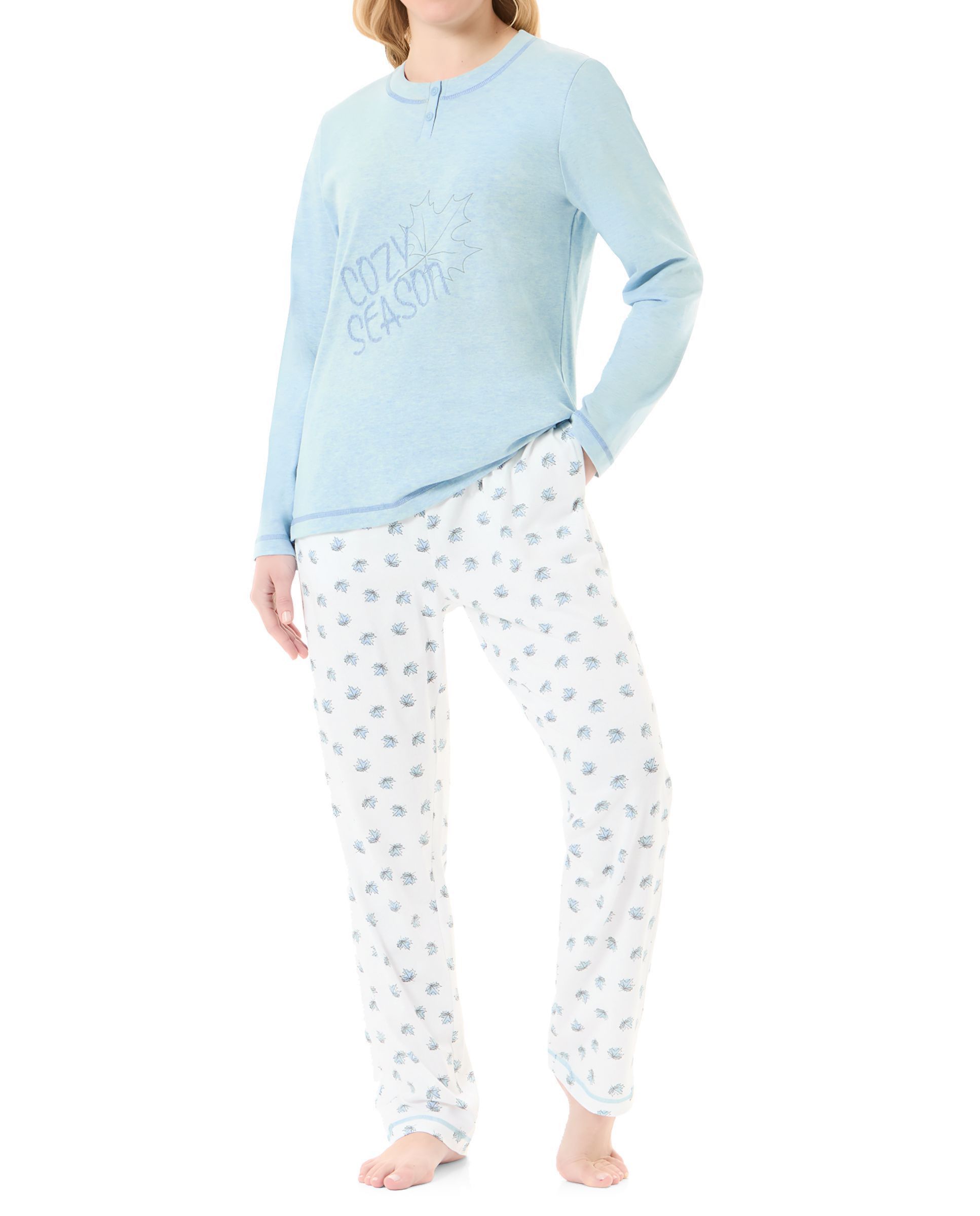 Woman in light blue winter pyjama jacket with embroidery and plain trousers with leaf print