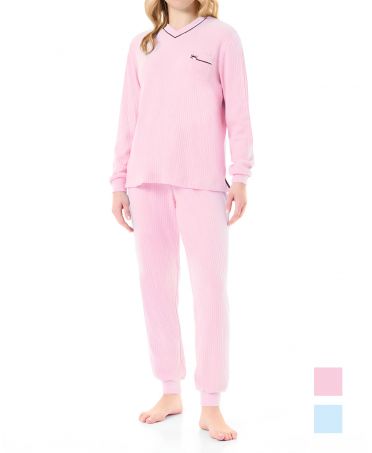 Woman in pink ribbed long pyjamas with long-sleeved jacket and plain cuffs and trousers