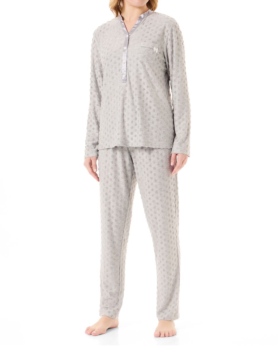 Woman in long winter pyjamas in polka dot and V-neck knitted fabric