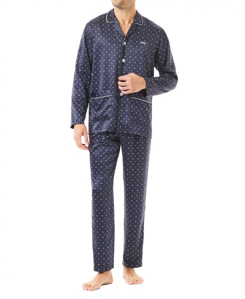 Man in blue satin Christmas pyjamas with open pockets and polka dot print