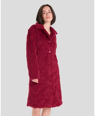 Woman in short red buttoned winter coat with side pockets.