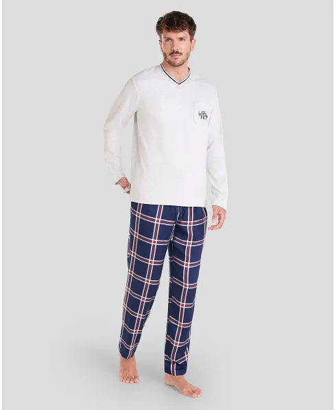 Man in long-sleeved Christmas pyjamas with checked trousers