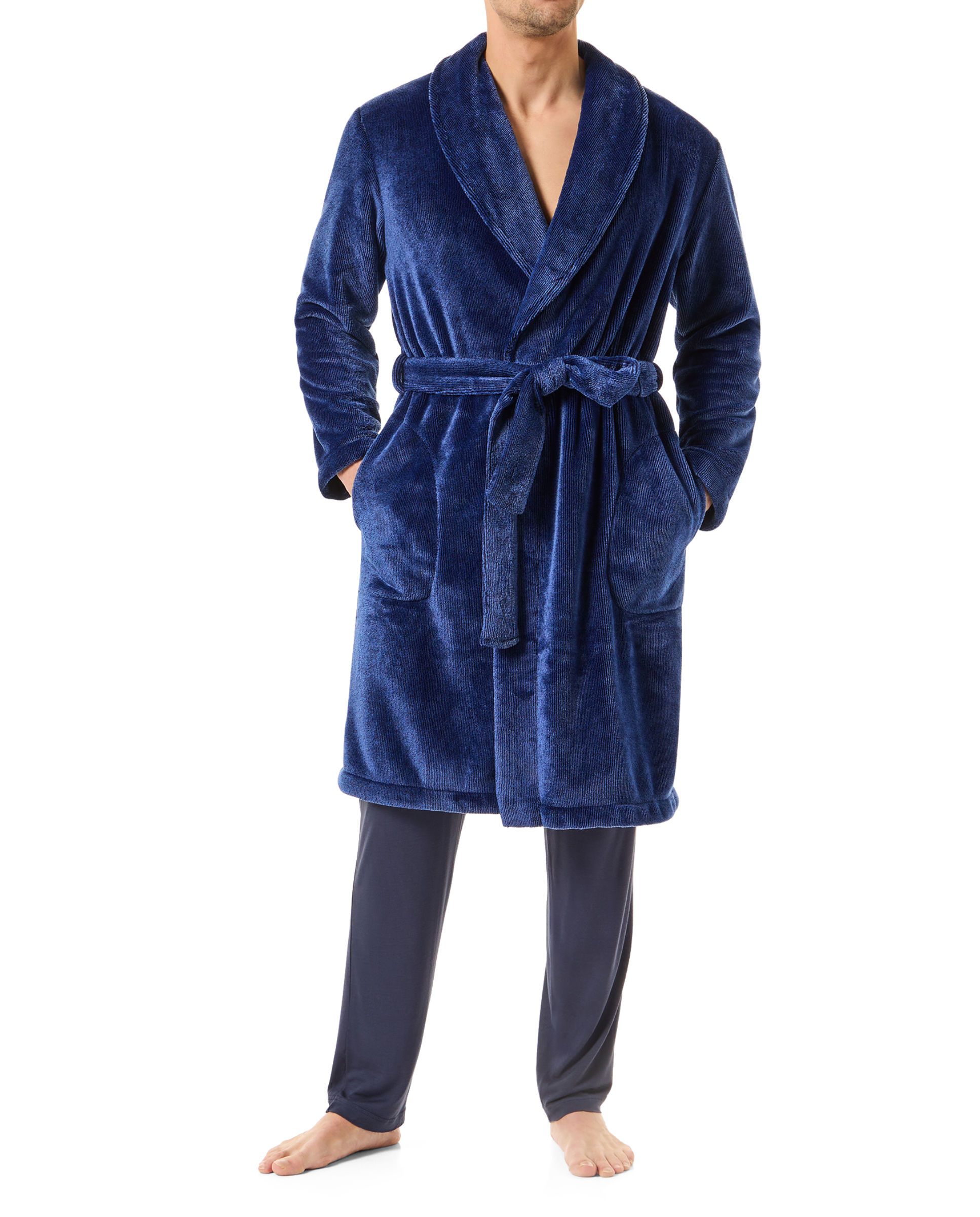 A man wearing a long blue knotted dinner jacket dressing gown