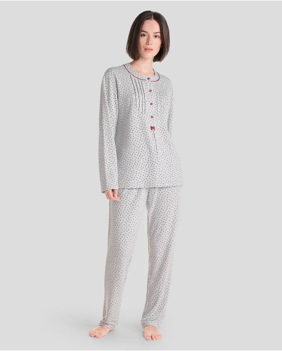 Woman in grey long winter pyjamas with closed collar with maroon flowers