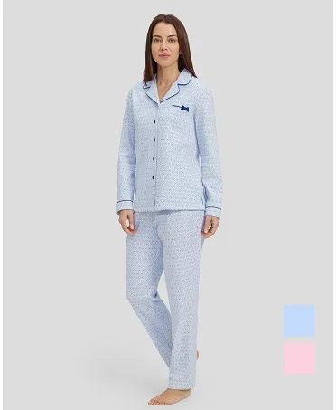 Woman in light blue shirt pyjamas with buttoned ovals and contrasting piped collar.