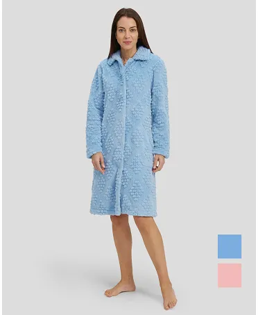 Woman in light blue jacquard long winter coat, buttoned and with pockets