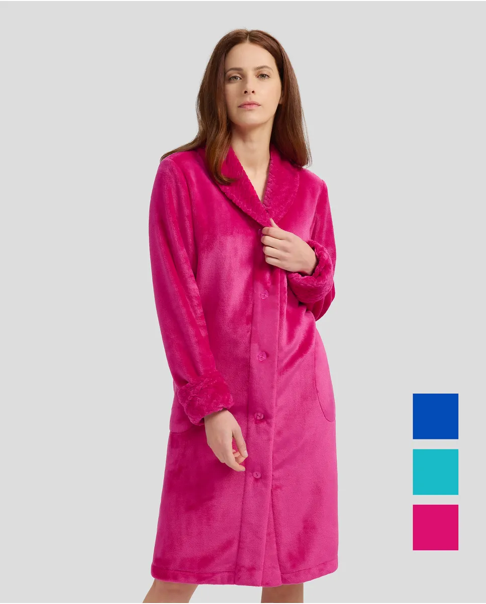 Woman in fuchsia flannel long dressing gown, buttoned and with pockets for winter